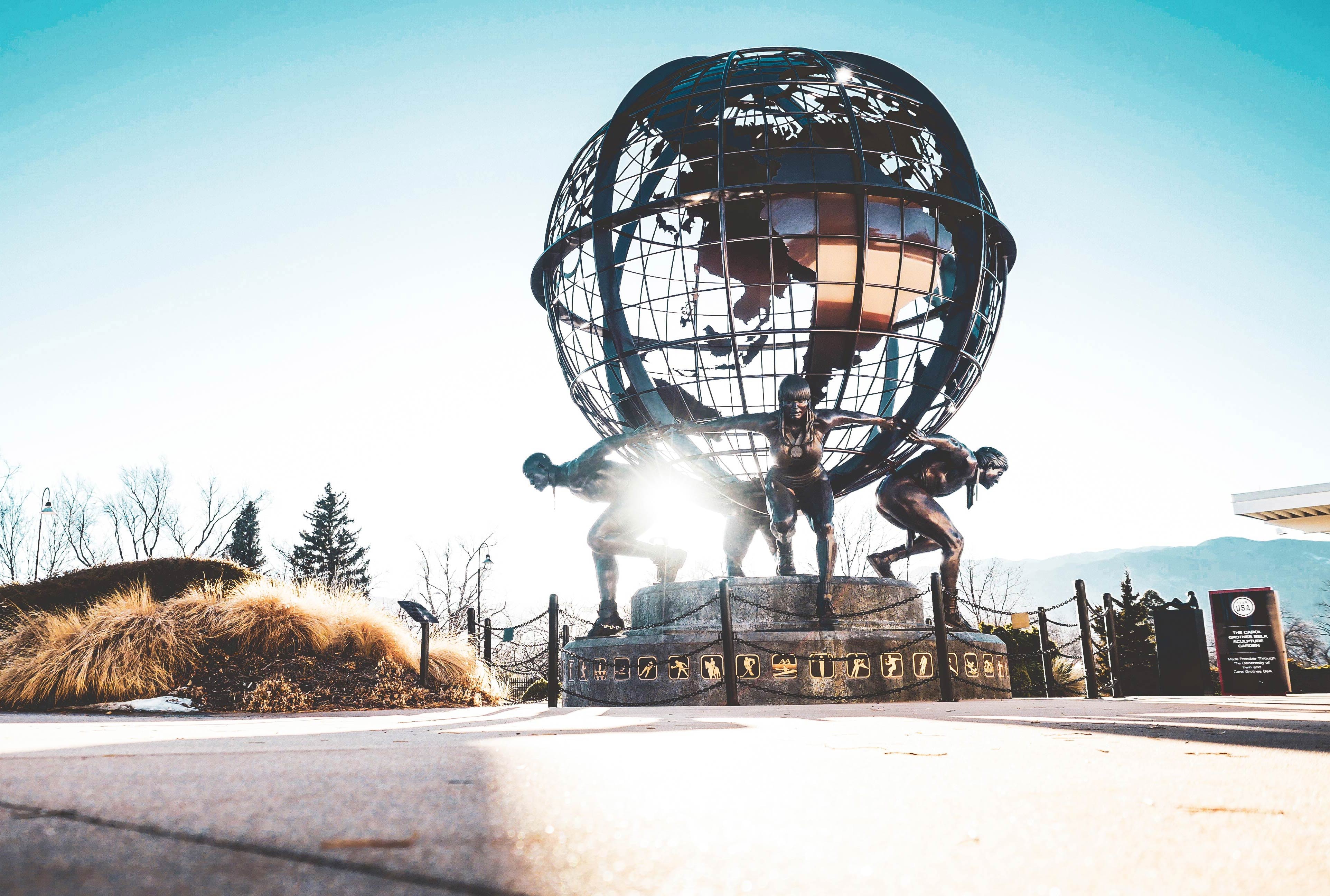 A bronze statue of four athletes carrying the world